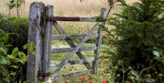 Old gate in garden leading to wildflower meadow at Leydens in Kent. Open for The NGS